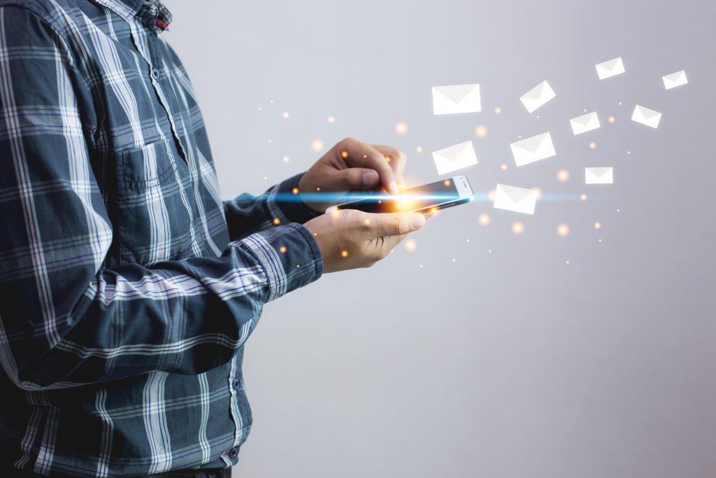 Man sending message and mobile phone with email icon . Business